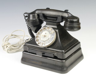 A black Bakelite dial telephone, the hand receiver marked 164H 143/1 complete with bell box 