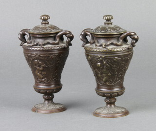 After the Antique, a pair of Victorian style bronze twin handled lidded urns decorated cherubs 12cm h x 5cm 
