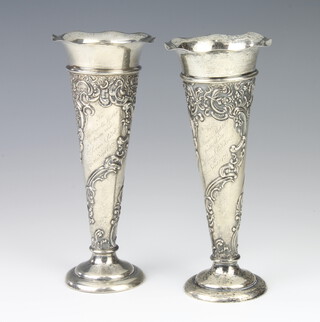 A pair of Edwardian silver tapered posy vases decorated with scrolls and flowers, London 1901, 16cm, weighted 