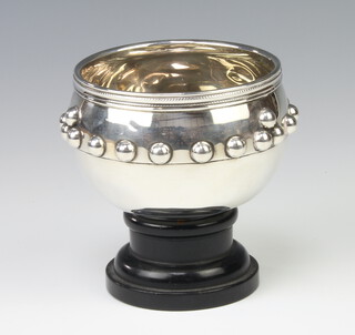 A silver bowl with applied roundels Birmingham 1911, 11cm, 146 grams, complete with wooden stand 