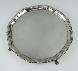 A silver salver with pie crust rim engraved S, raised on hoof feet, London 1940, 25cm, 650 grams 
