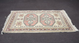 A Caucasian style brown and white ground rug with 2 octagons to the centre within a multi row border 205cm x 139cm 