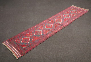 A red and blue ground Meshwani runner with 6 diamonds to the centre 260cm x 62cm 