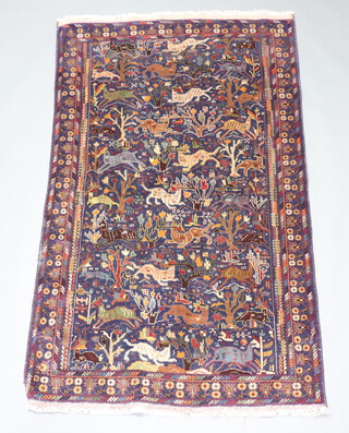 A blue ground Persian rug decorated trees and animals within 199cm x 121cm 