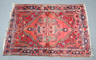 A red and green Afghan rug with diamonds to the centre 129cm x 103cm 