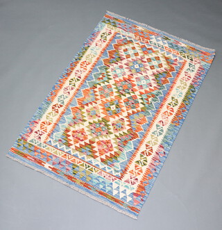 A white, blue and brown ground Chobi Kilim rug with all over geometric design within a multi row border 175cm x 115cm 