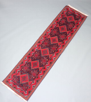 A red and blue ground Meshwani runner with 6 diamonds to the centre 262cm x 96cm 