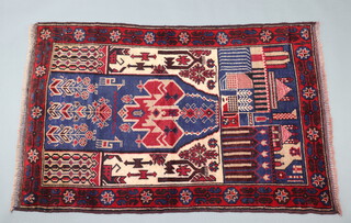 A blue and red ground Belouche rug decorated buildings 150cm x 95cm 