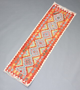 A white, yellow and green ground Chobi Kilim runner with overall geometric designs 200cm x 61cm 