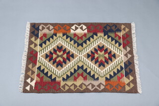 A black, brown and tan ground Maimana Kilim rug with diamonds to the centre 92cm x 63cm 