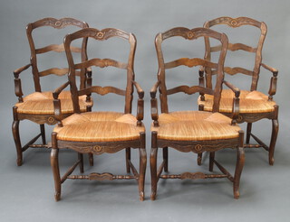 A set of 4 French carved elm ladder back carver chairs with woven rush seats raised on cabriole supports 102cm h x 57cm w x 51cm d (seat 38cm x 33cm) 