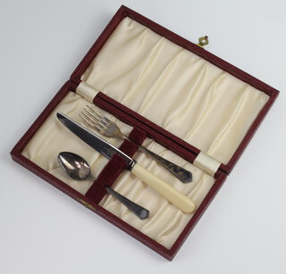 A silver 3 piece christening set, the fork and spoon Sheffield 1947 36 grams, with later associated knife with simulated bone handle and stainless steel blade, cased 