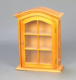 A walnut finished arch shaped display cabinet fitted shelves enclosed by a glazed panelled door 52cm h x 38cm w x 15cm d 