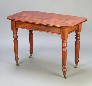 A Victorian oval mahogany occasional table raised on turned supports ending in brass caps and casters 73cm h x 105cm x 57cm 