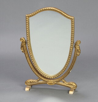 A Sheraton style shield shaped dressing table mirror contained in a gilt frame 49cm x 29cm x 10cm 