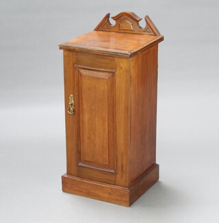 A Victorian walnut bedside cabinet with raised back enclosed by a panelled door, raised on a platform base 82cm h x 36cm w x 34cm d 