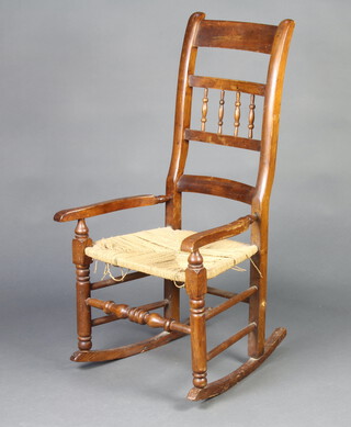 A 19th Century elm and beech ladder back rocking chair with spindle turned decoration and woven rush seat 102cm h x 57cm w x 53cm d (seat 27cm x 29cm)  