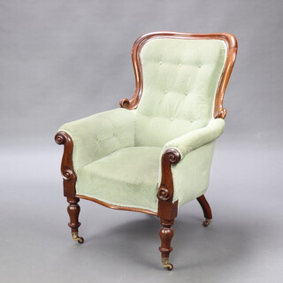A Victorian mahogany show frame armchair upholstered in buttoned green material, raised on turned supports 113cm h x 71cm w x 60cm d (seat 34cm x 40cm) 