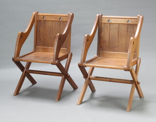 A pair of Victorian pitch pine Glastonbury chairs with gothic decoration 91cm h x 54cm w x 44cm d 