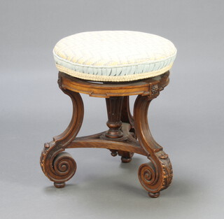 A Victorian circular carved walnut revolving piano stool having turned and fluted column to the side, raised on shaped supports 48cm h x 41cm diam. 