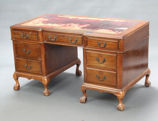 A Queen Anne style mahogany inverted breakfront pedestal desk with inset leather writing surface, fitted 1 long and 6 short drawers, raised on cabriole ball and claw supports 74cm h x 138cm w x 75cm d 