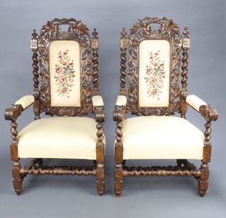 A pair of Victorian carved and pierced oak open arm chairs, the seats and backs upholstered in white material, raised on turned and block supports with H framed stretchers 124cm h x 66cm w x 62cm d (seat 37cm x 36cm) 