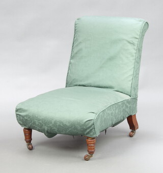 A Victorian nursing chair upholstered in green material, raised on turned supports 76cm h x 59cm w 61cm (seat 42cm x 39cm)  