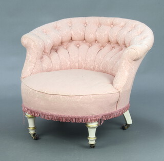 A Victorian metal framed low tub back chair upholstered in pink buttoned material, raised on turned and fluted supports 60cm h x 77cm w x 70cm d (seat 40cm x 35cm) 