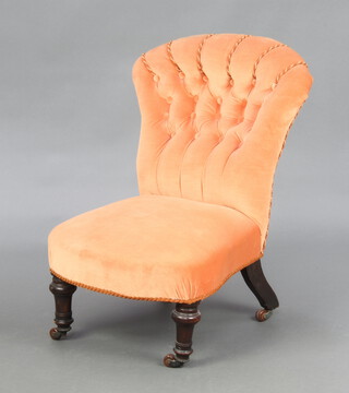 A Victorian nursing chair upholstered in orange buttoned material, raised on turned supports 70cm h x 43cm w x 44cm d (seat 25cm x 30cm) 