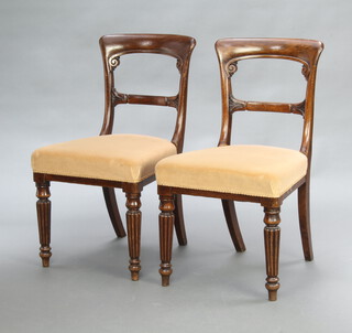 A pair of Victorian mahogany bar back dining chairs with shaped mid rails and overstuffed seats, raised on turned and reeded supports 85cm h x 48cm w x 45cm 