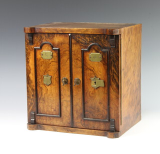 A Victorian figured walnut smoker's cabinet in the form of a 2 doored safe, the front marked RD76871, the interior fitted 2 short drawers above 1 long drawer with recess and pipe rack (1 aperture on the pipe rack is f), also fitted a cigar cutter and together with a small associated horn snuff box, the brass escutcheon to the front is marked Secure Lever 32cm h x 31cm w x 34cm d  