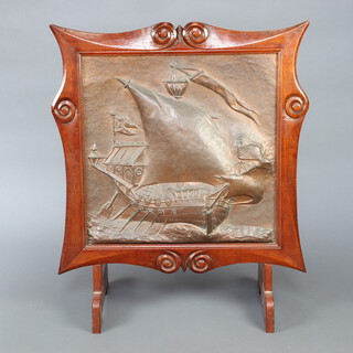 An Art Nouveau oak and embossed copper firescreen, the central panel decorated a galleon in full sail, contained in a carved oak surround 86cm h x 73cm w x 32cm d  