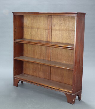 A mahogany open bookcase fitted adjustable shelves raised on bracket feet 124cm h x 121cm w x 25cm d 