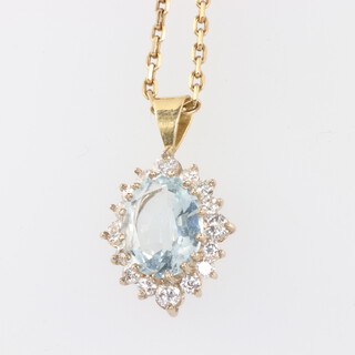 A yellow metal oval topaz and diamond pendant the centre stone 11mm x 9mm, the 16 brilliant cut diamonds approx. 0.05mm, 25mm x 15mm, 4.1 grams together with a 9ct yellow gold necklace 4.2 grams 44cm
