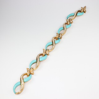 A 1970's yellow metal stamped 750, turquoise and diamond bracelet comprising 115 diamonds graduating between 0.01 and 0.03ct, 31.9 grams gross, 20.5cm 