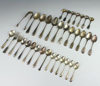 A Georgian silver dessert spoon with rubbed marks, together with minor silver spoons and forks, 600 grams 