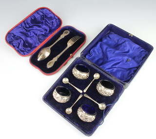 A cased Victorian silver christening fork and spoon London 1897 together with a set of 4 Edwardian silver salts and spoons, 146 grams, both cased