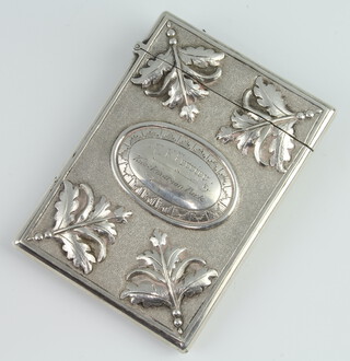 A Victorian cast silver card case decorated with leaves and flowers with presentation inscription E K Ferrier Knockmaroon Park, 106 grams, London 1877, maker S Mordan & Co. 
