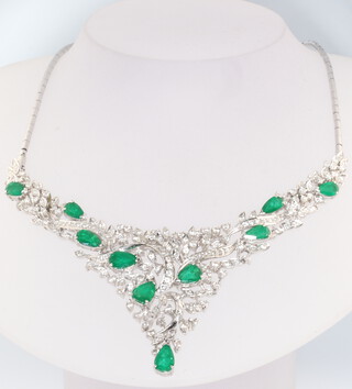 A white metal stamped 14k emerald and diamond necklace set with 9 pear cut emeralds approx. 6ct and brilliant cut diamonds approx. 3ct, gross weight 35 grams 