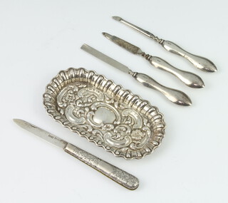 An Edwardian repousse silver pin tray 12cm, a silver fruit knife and 3 nail implements 