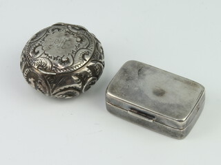 A Victorian silver circular pill box with repousse decoration together with a rectangular silver box 36 grams