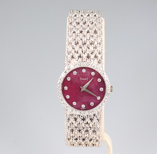 A lady's Piaget 18ct white gold cocktail watch with rhodochrosite dial, diamond 5 minute markers and diamond bezel, contained in a 33mm case, the 36 diamonds approx. 0.02ct each, the back of the case is numbered 9706N39.182368, gross weight 55.6 grams, contained in a Piaget box 