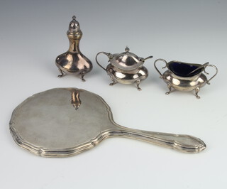 A silver 3 piece condiment Birmingham 1923/24, 158 grams, together with a silver backed hand mirror 