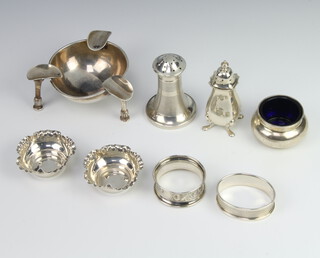 A circular silver ashtray raised on turned legs Birmingham 1924, 3 salts, 2 napkin rings and a condiment, weighable silver 200 grams