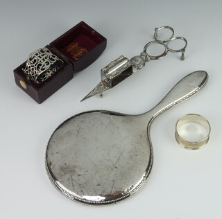 A silver napkin ring Sheffield 1914 cased, 1 other 40 grams, a silver backed hand mirror and a pair of plated snuffers
