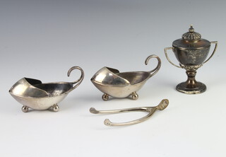 A pair of Edwardian silver wishbone sugar nips London 1902 by Asprey & Co, a pair of boat shaped condiments and a 2 handled trophy cup, 116 grams 