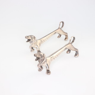 A pair of Edwardian silver plated novelty Dachshund knife rests  