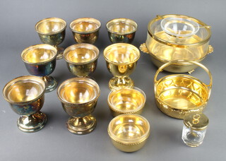 A gilt caviar set with glass liner, 2 bowls, a basket and a jar and cover and 8 gilt metal cups with glass liners 