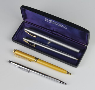 A steel cased Cross fountain pen, a ditto ballpoint pen, a Cross propelling pencil and a ballpoint pen 