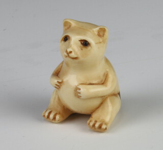 A Meiji Period Japanese ivory netsuke in the form of a seated cat, signed 3cm 